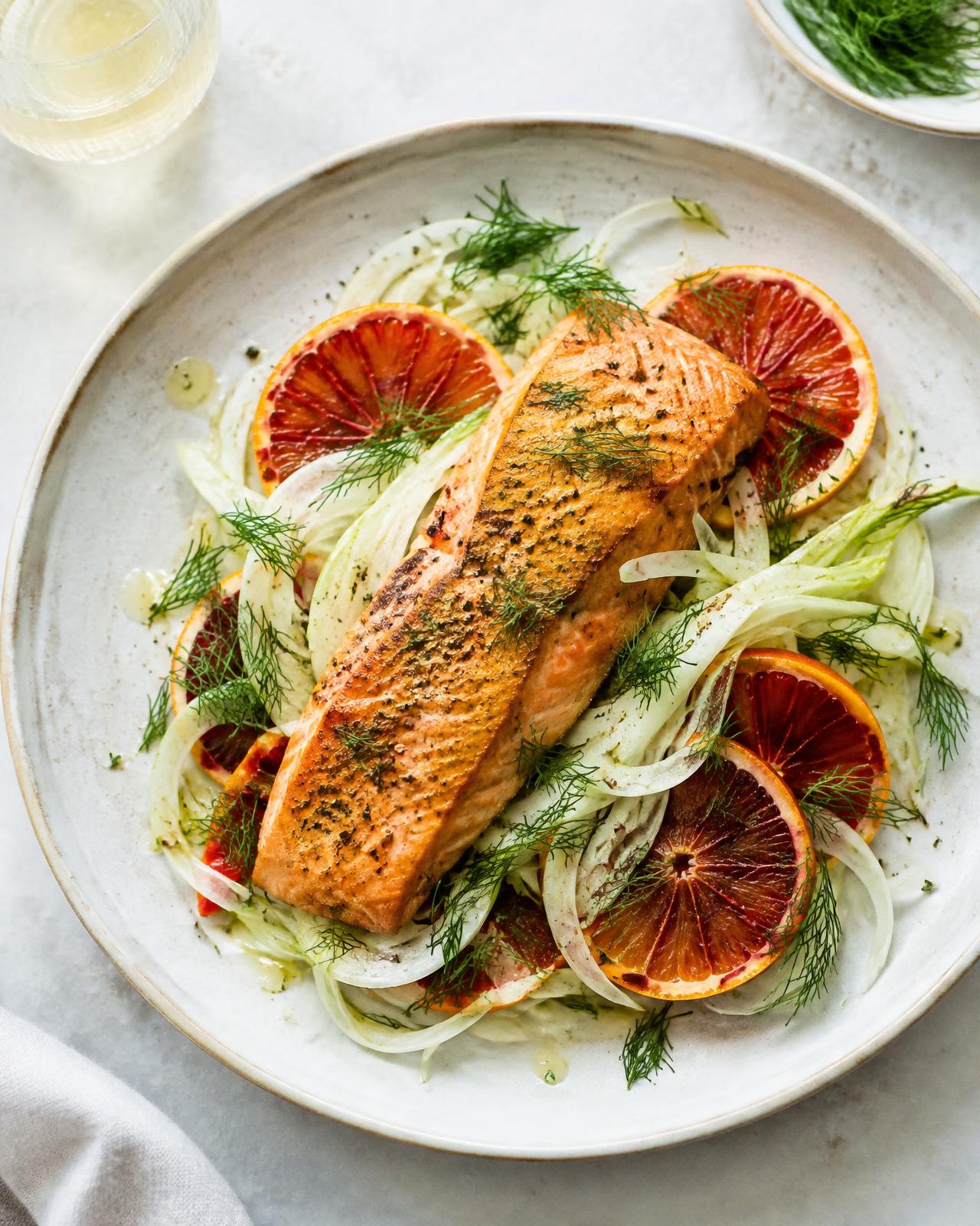 Roast salmon fillet on shaved fennel with blood orange slices and dill